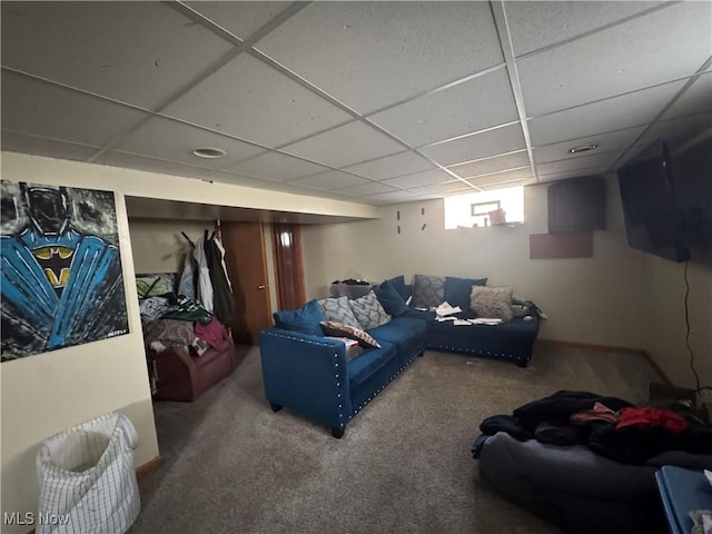 living area featuring carpet flooring and a paneled ceiling