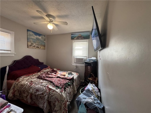bedroom with a textured ceiling and ceiling fan