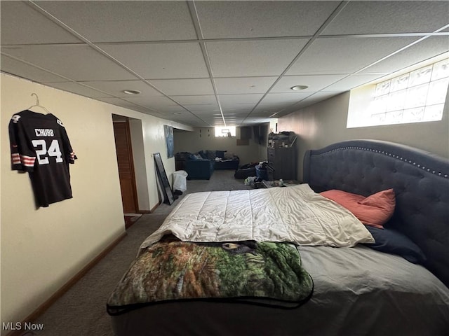 bedroom with carpet flooring and a drop ceiling