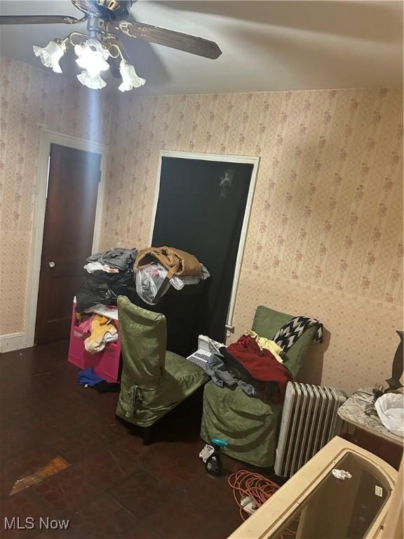 misc room with wallpapered walls and ceiling fan