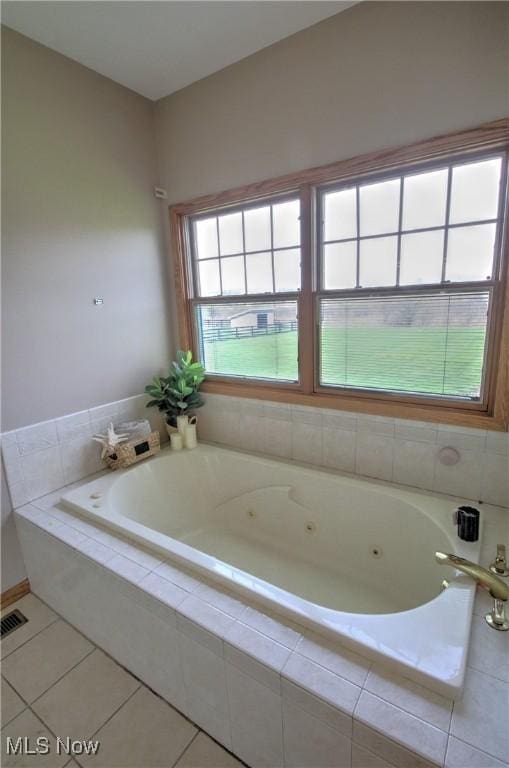 full bath with tile patterned floors, visible vents, and a tub with jets