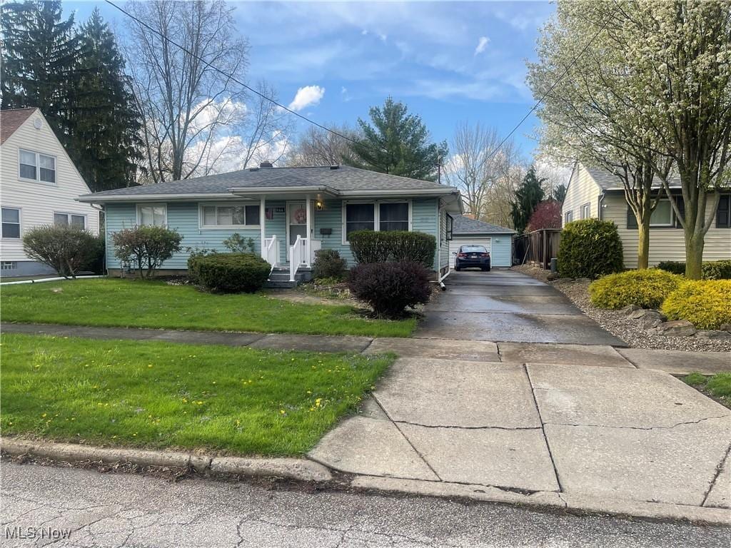 1166 Raymond St NW, Warren, OH 44485 - view of front of home with a front yard and a garage