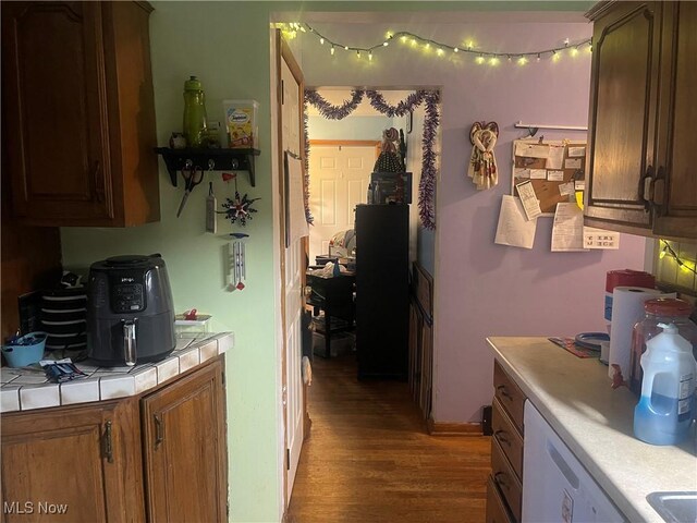 1166 Raymond St NW, Warren, OH 44485 - kitchen with tile counters, wood finished floors, and white dishwasher