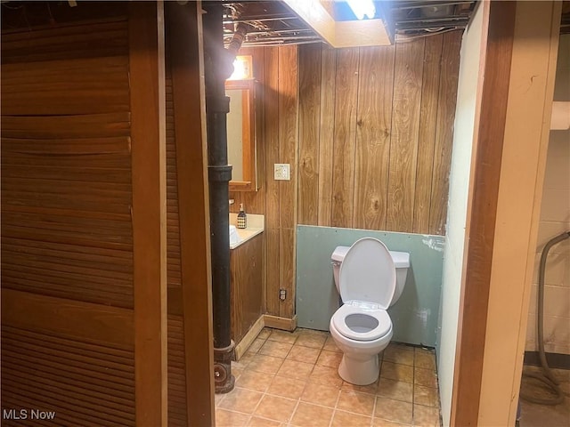 1166 Raymond St NW, Warren, OH 44485 - half bathroom featuring wooden walls, vanity, and tile patterned floors