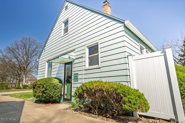 3867 E 177th St, Cleveland, OH 44128 - view of property exterior featuring a chimney