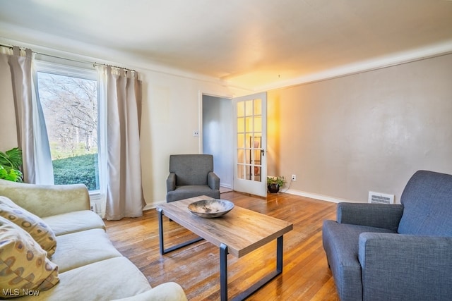 3867 E 177th St, Cleveland, OH 44128 - living room featuring wood finished floors, visible vents, and plenty of natural light