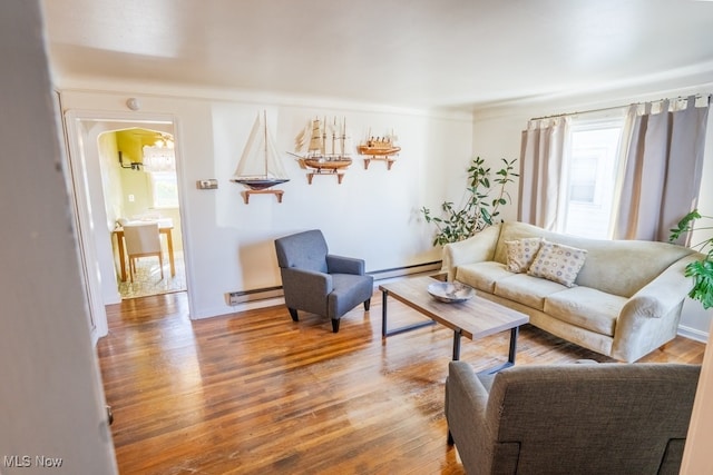 3867 E 177th St, Cleveland, OH 44128 - living area featuring a baseboard radiator, wood finished floors, and baseboards