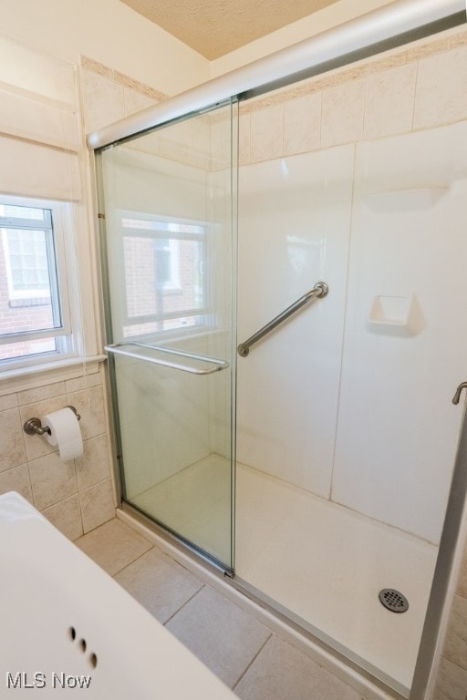 3867 E 177th St, Cleveland, OH 44128 - full bath with tile walls, tile patterned floors, and a stall shower