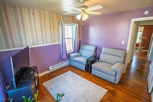 3867 E 177th St, Cleveland, OH 44128 - sitting room featuring baseboards, wallpapered walls, baseboard heating, wood finished floors, and ceiling fan