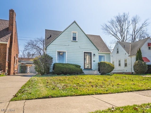 3867 E 177th St, Cleveland, OH 44128 - bungalow featuring roof with shingles and a front lawn