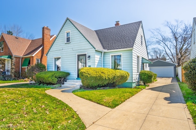 3867 E 177th St, Cleveland, OH 44128 - bungalow with a chimney, a front lawn, a detached garage, and an outdoor structure