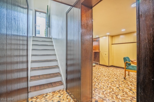 3867 E 177th St, Cleveland, OH 44128 - staircase featuring recessed lighting and wooden walls