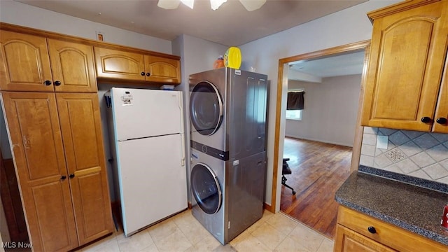 14513 Mission Rd, Cleveland, OH 44135 - laundry area featuring stacked washer and dryer, baseboards, and laundry area