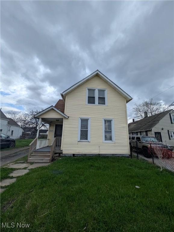 3369 E 49th St, Cleveland, OH 44127 - traditional-style home with a front yard and fence
