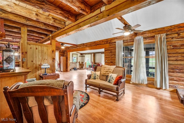 24455 Tryon Rd, Bedford, OH 44146 - living room featuring wood ceiling, wood finished floors, a ceiling fan, beam ceiling, and log walls
