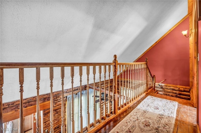 24455 Tryon Rd, Bedford, OH 44146 - staircase with a textured ceiling and vaulted ceiling