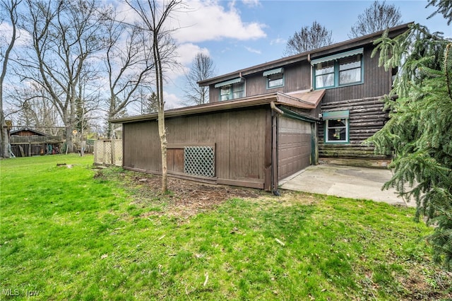 24455 Tryon Rd, Bedford, OH 44146 - rear view of house with concrete driveway and a yard