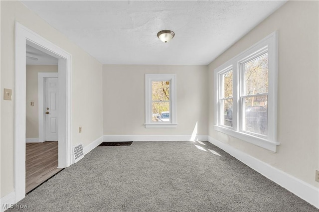 201 Alberti Ct, Akron, OH 44310 - carpeted empty room with baseboards and a textured ceiling