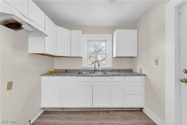 201 Alberti Ct, Akron, OH 44310 - kitchen with a sink, baseboards, light wood-style floors, and white cabinets