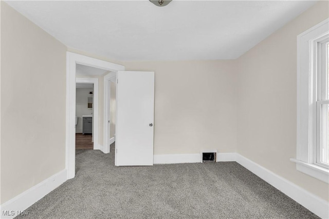 201 Alberti Ct, Akron, OH 44310 - spare room featuring carpet flooring, baseboards, and healthy amount of natural light