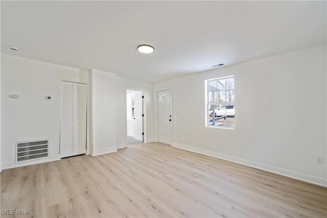 interior space featuring light wood-style flooring, visible vents, and baseboards