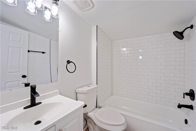 bathroom featuring toilet, visible vents, vanity, and tub / shower combination