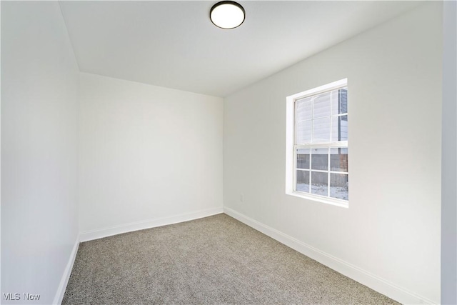 carpeted empty room with baseboards