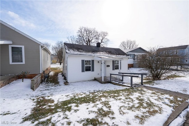exterior space with fence and a chimney