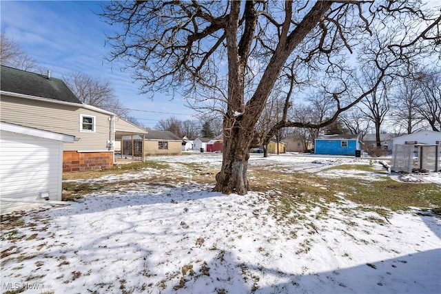 yard covered in snow with an outdoor structure