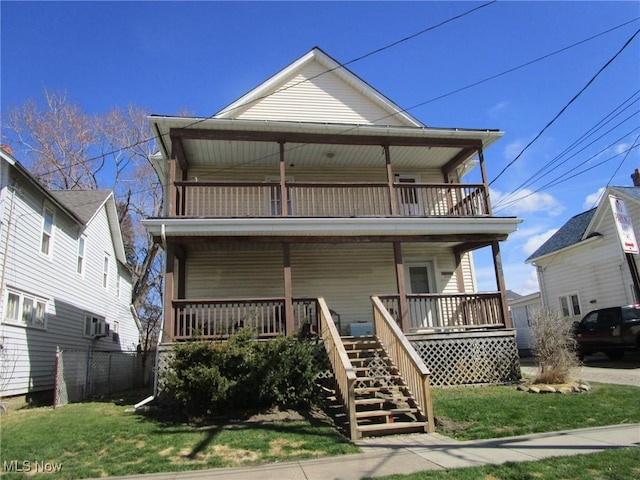 view of front of property featuring stairway, covered porch, a front lawn, and a balcony