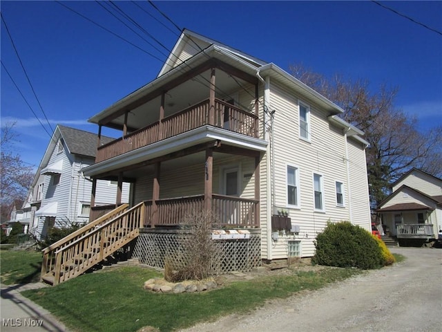 exterior space with a porch and a balcony