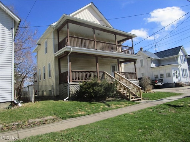 view of front of home featuring a porch, a front yard, and a balcony