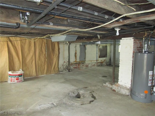 unfinished basement featuring gas water heater