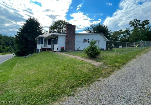 142 W Main St, Hopedale, OH 43976 - view of front facade with fence, a chimney, and a front yard