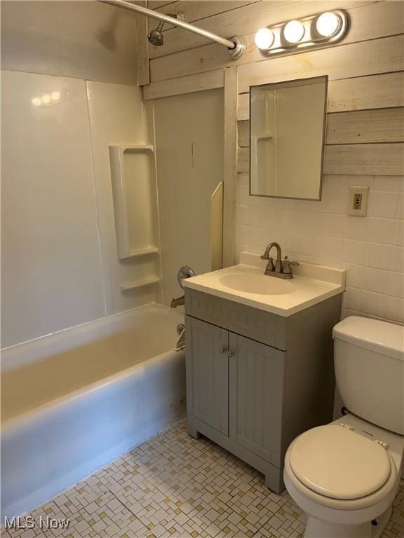 bathroom with shower / bathing tub combination, tile patterned floors, vanity, and toilet