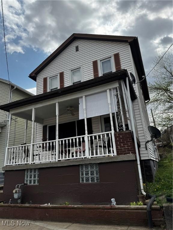 1514 Commerce St, Wellsville, OH 43968 - back of house featuring a porch and brick siding
