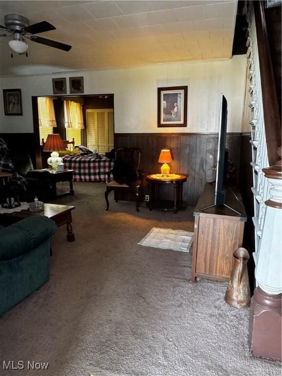 1514 Commerce St, Wellsville, OH 43968 - living room with wooden walls, a wainscoted wall, carpet flooring, and a ceiling fan