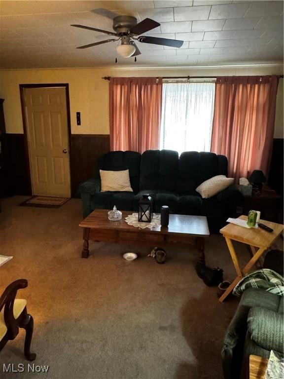 1514 Commerce St, Wellsville, OH 43968 - living room featuring a ceiling fan, a wainscoted wall, and carpet floors