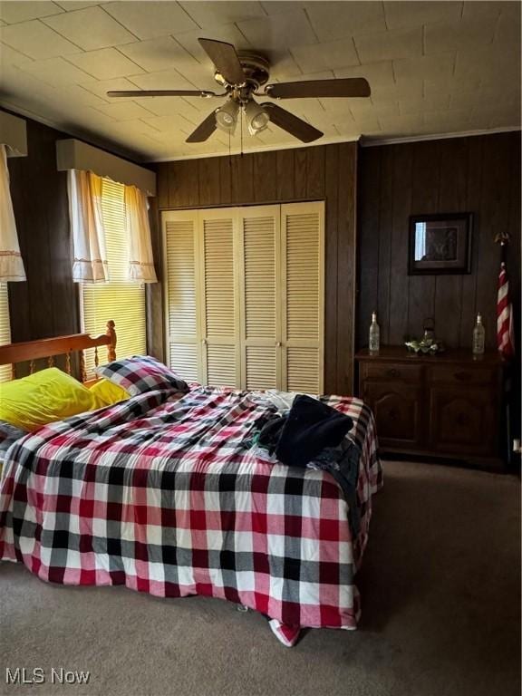 1514 Commerce St, Wellsville, OH 43968 - bedroom with a ceiling fan, wooden walls, a closet, and carpet