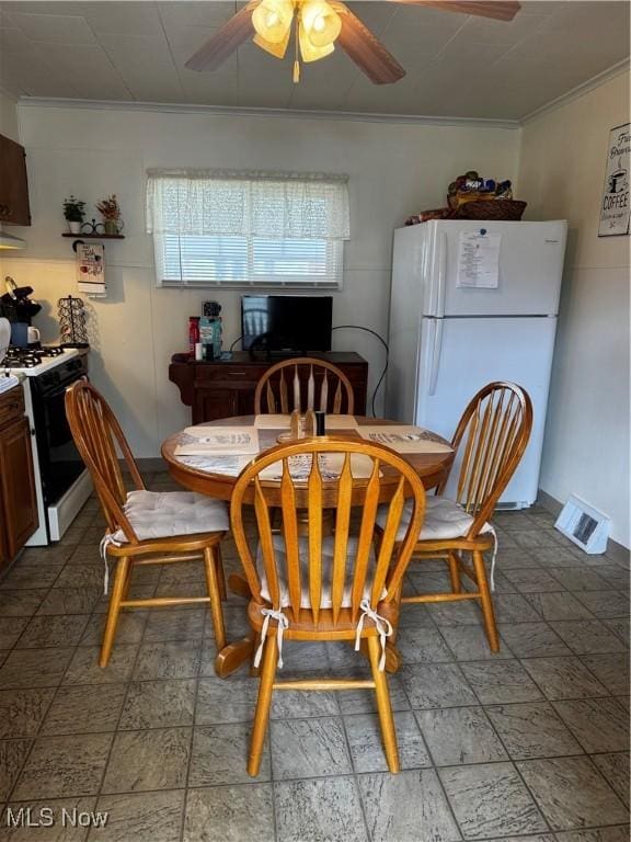 1514 Commerce St, Wellsville, OH 43968 - dining area featuring visible vents, a ceiling fan, and ornamental molding