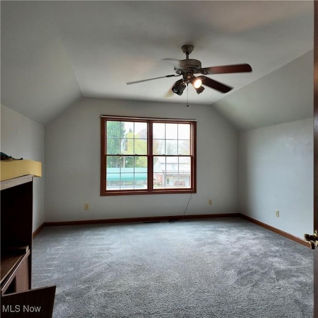 bonus room with lofted ceiling, a ceiling fan, carpet floors, and baseboards