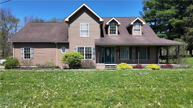 view of front of property with roof with shingles, a front yard, and covered porch