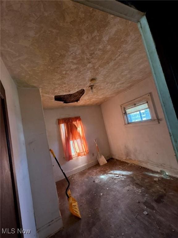 spare room with baseboards
