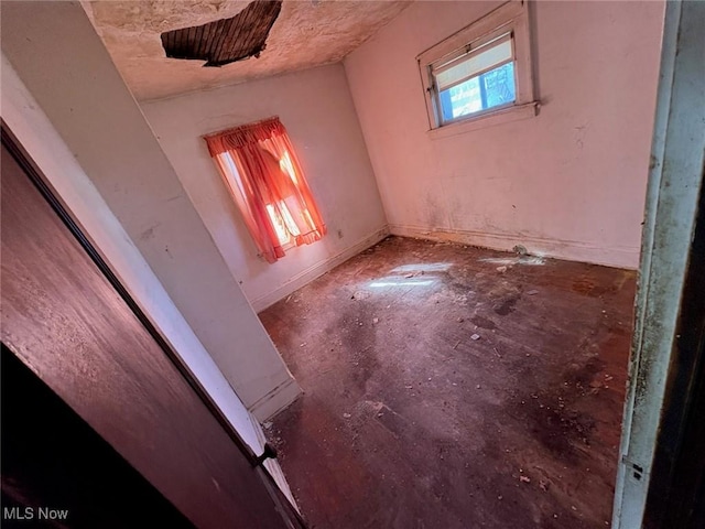 unfurnished room featuring concrete flooring