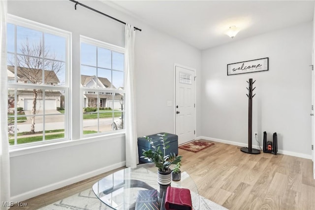 dining room with baseboards, wood finished floors, and a wealth of natural light