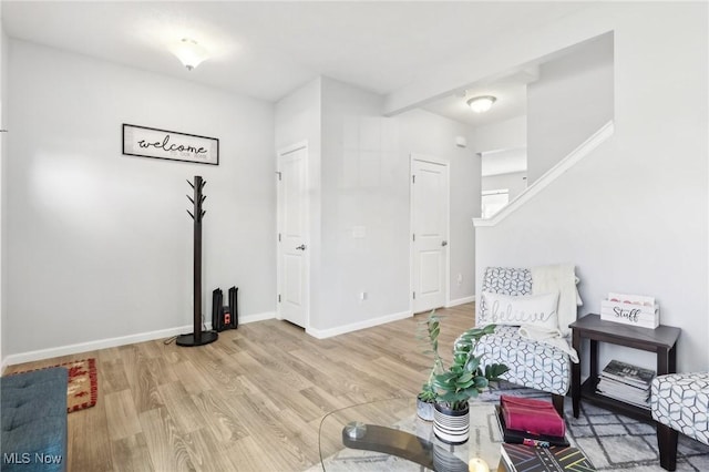 sitting room featuring baseboards and wood finished floors