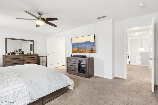 carpeted bedroom featuring visible vents, baseboards, and ceiling fan