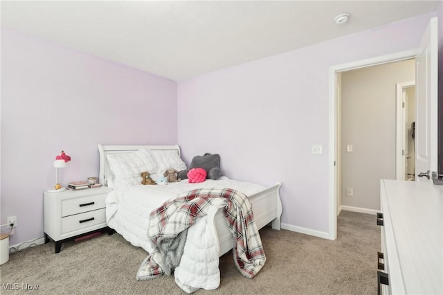 bedroom featuring baseboards and carpet flooring