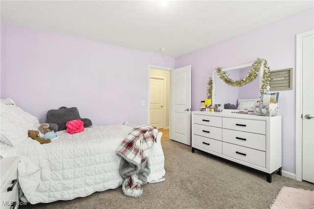 bedroom with light carpet and baseboards