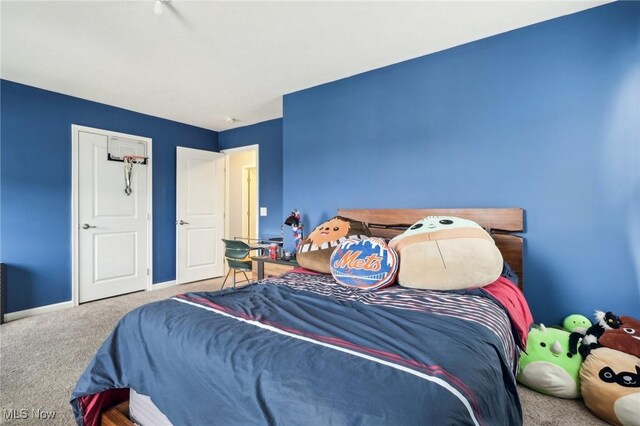 carpeted bedroom featuring baseboards